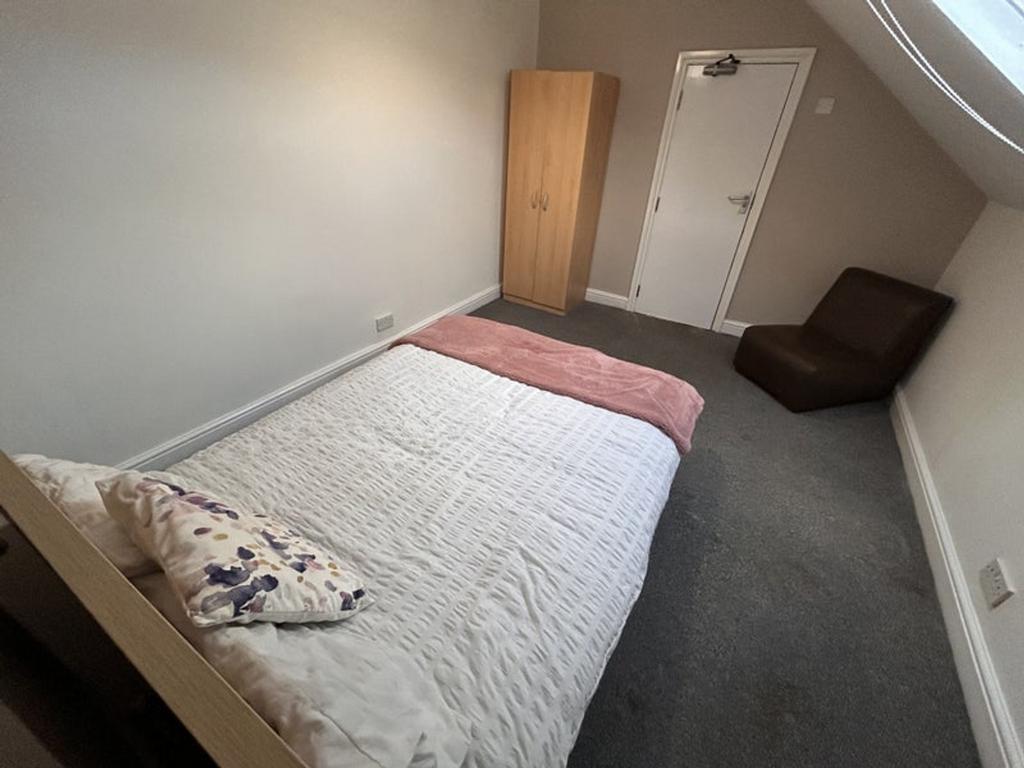 This inviting double bedroom features a cozy la...