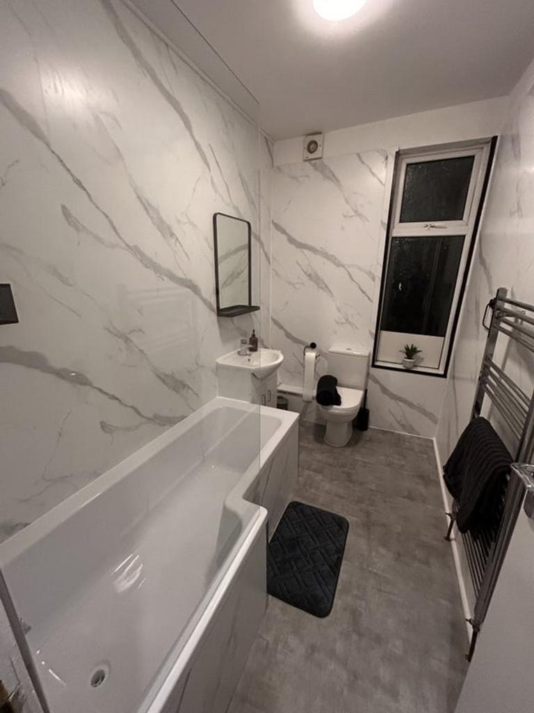 Stylishly designed bathroom suite featuring a s...