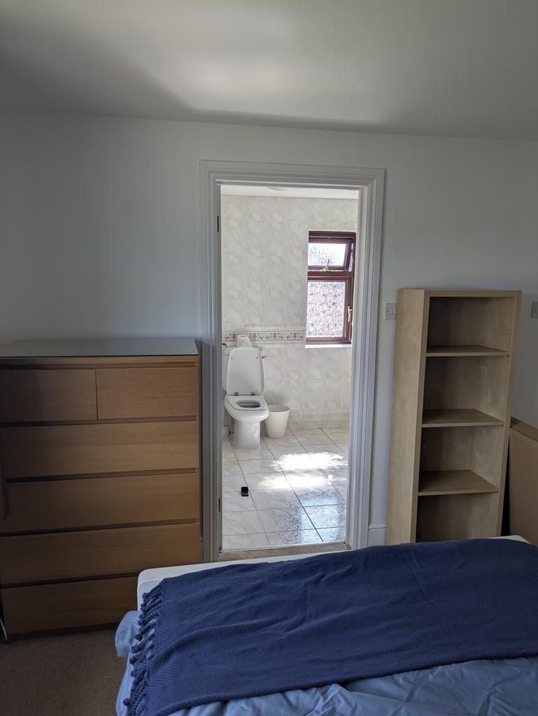 A cozy and well-lit double bedroom featuring a ...