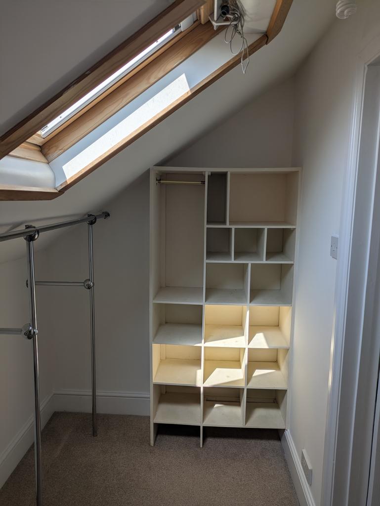 A cozy storage area enhanced by natural light f...