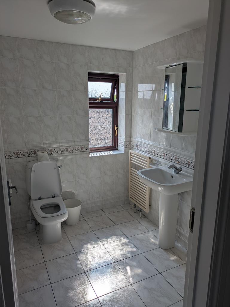 Bright and spacious bathroom with elegant tile ...