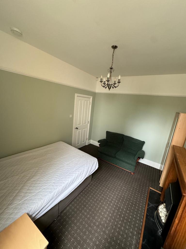 Spacious double bedroom featuring a comfortable...
