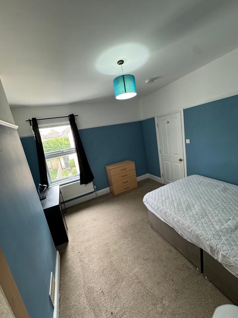 Spacious double bedroom featuring a contemporar...