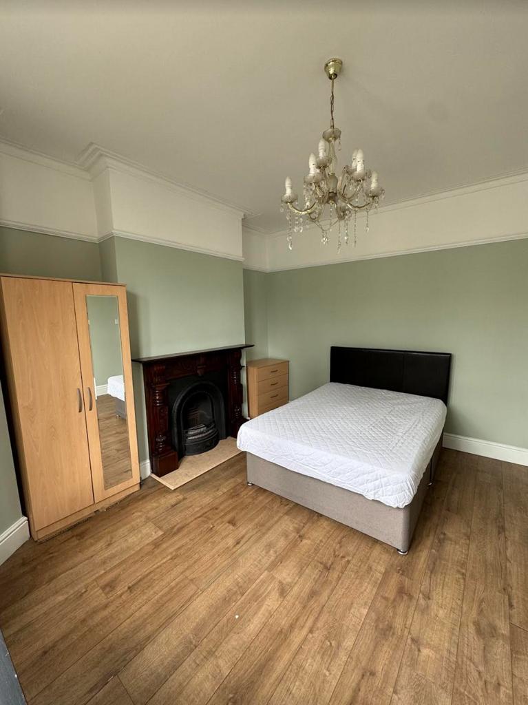 A charming double bedroom featuring a classic f...