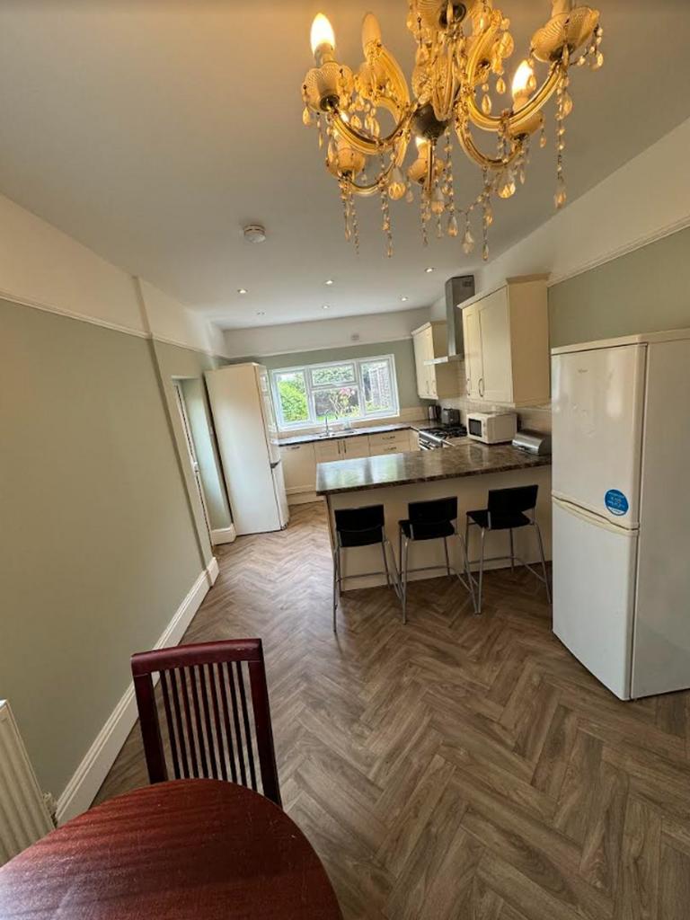 A spacious and bright kitchen with modern appli...