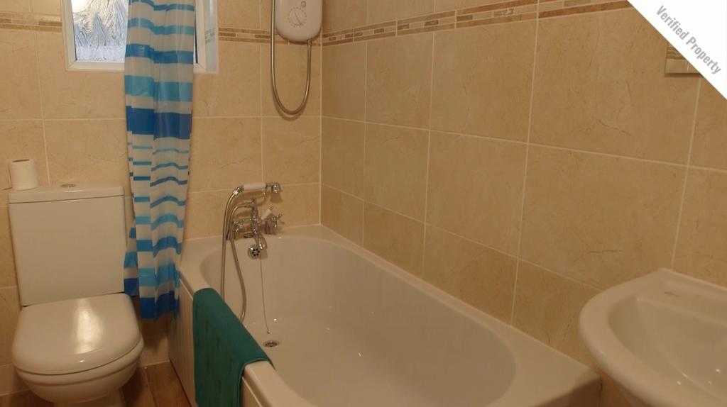 A bright and tidy bathroom featuring a relaxing...