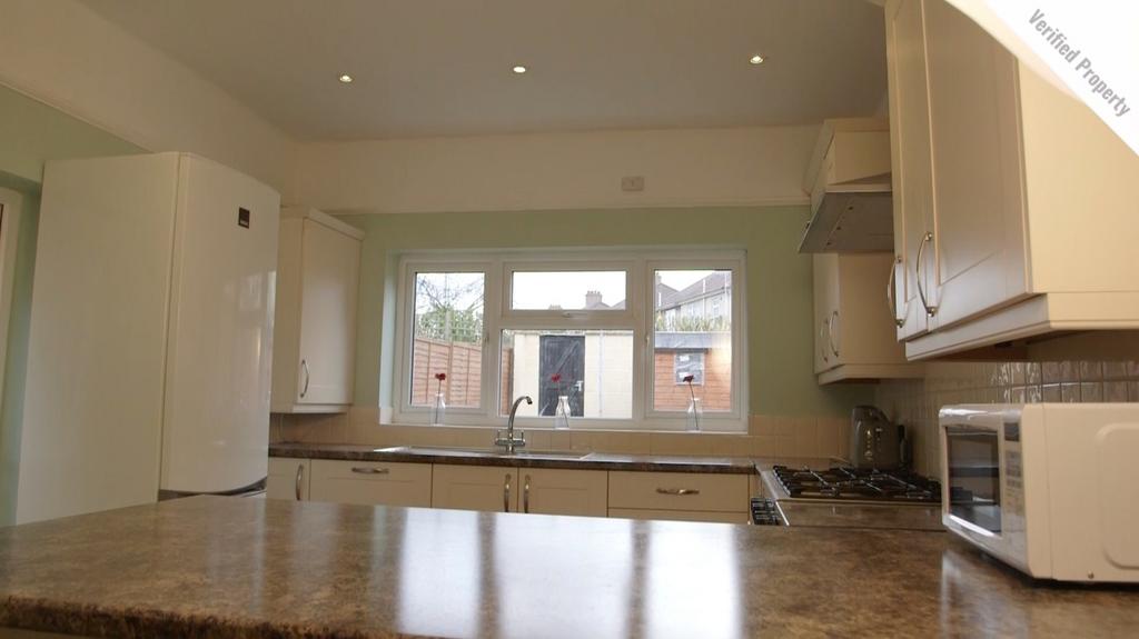 A bright and clean kitchen with ample natural l...