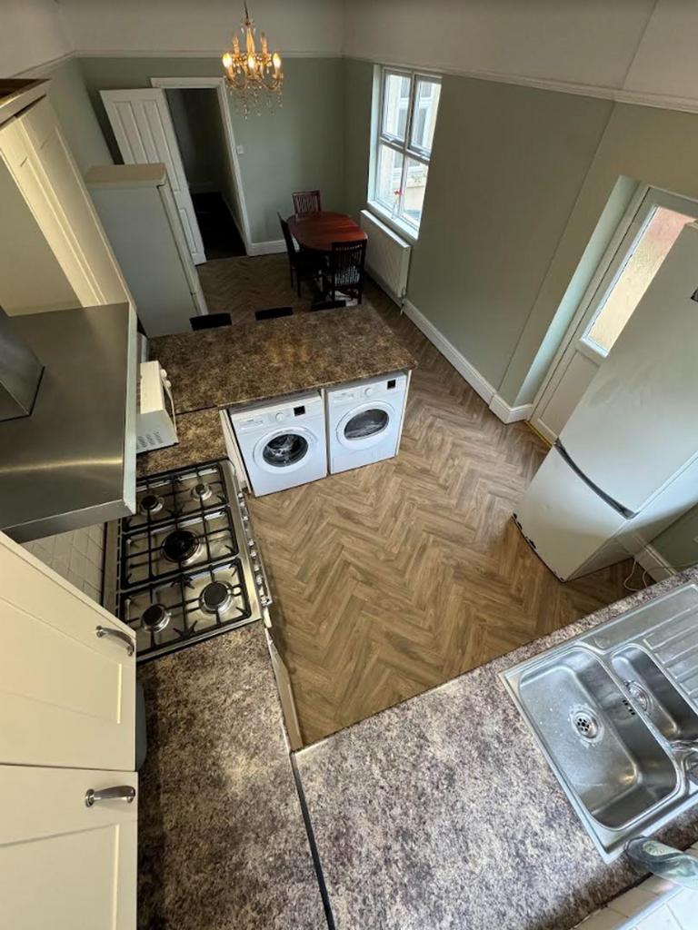 A spacious and tidy kitchen featuring modern ap...