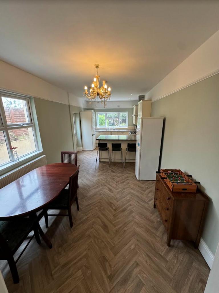 A spacious and well-lit kitchen with a charming...