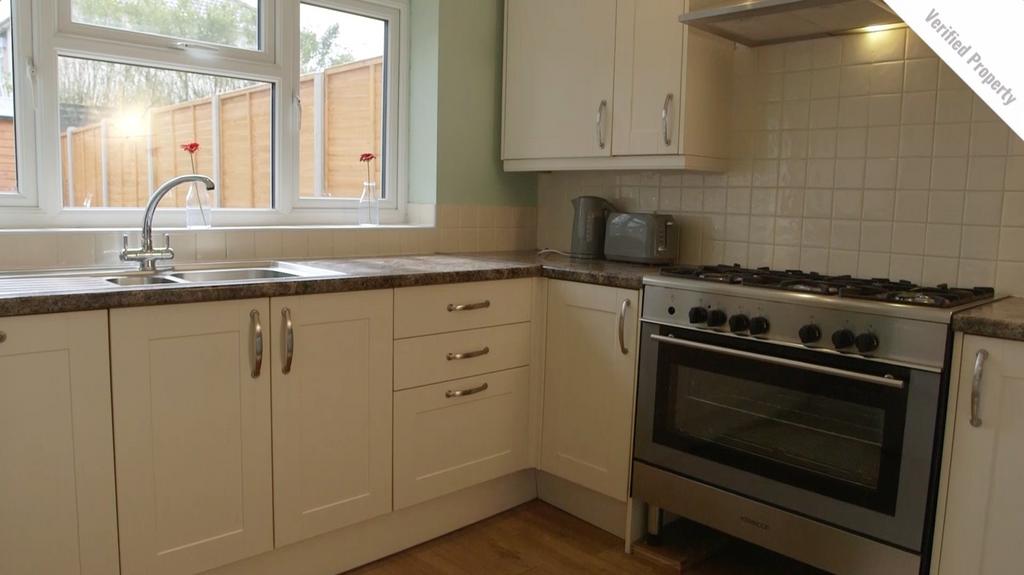 A bright and tidy kitchen featuring modern appl...
