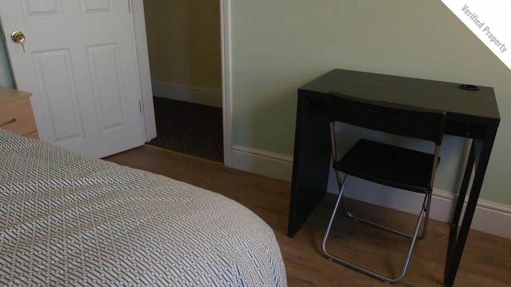 A tidy double bedroom featuring a comfortable b...