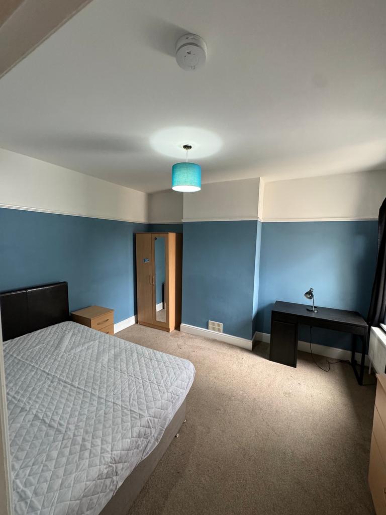 Bright and spacious double bedroom featuring a ...