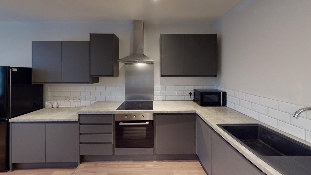 A modern and spacious kitchenette with sleek ca...
