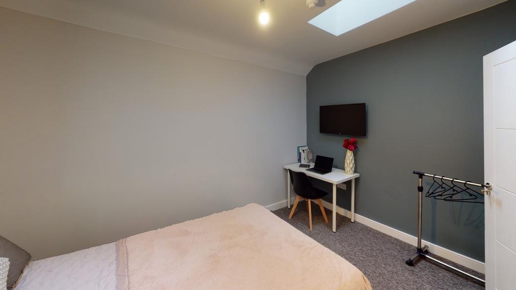A spacious and inviting double bedroom featurin...