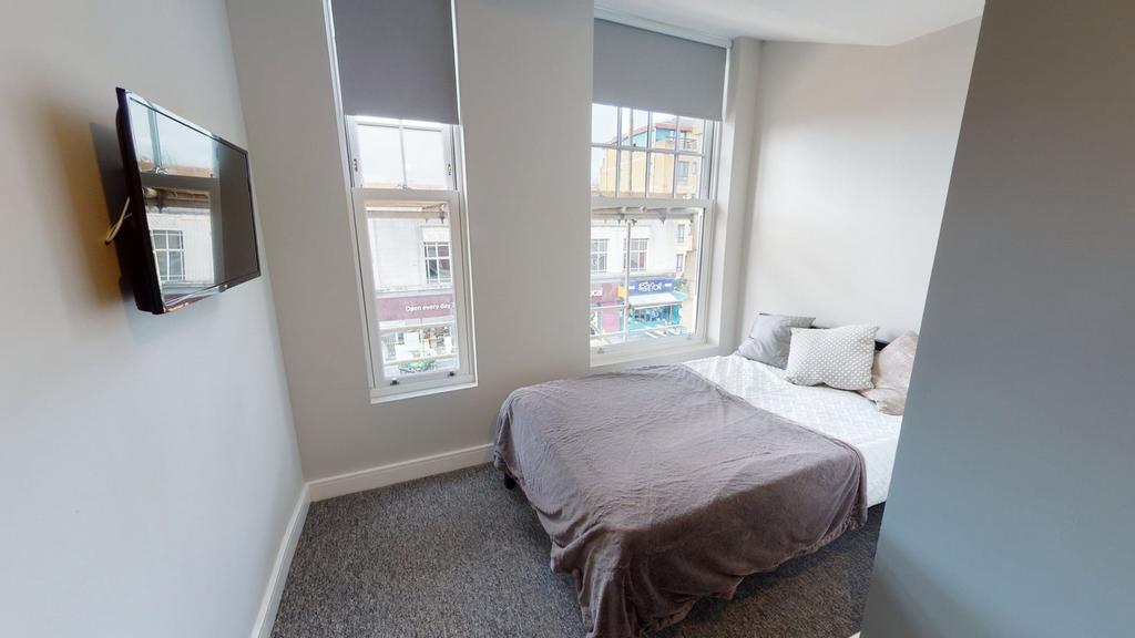 A bright and inviting double bedroom featuring ...