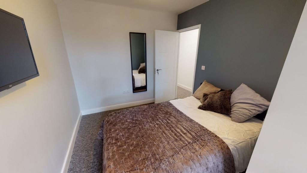 A cozy and inviting double bedroom with a styli...