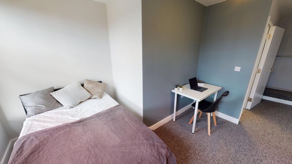 A cozy and inviting double bedroom featuring a ...