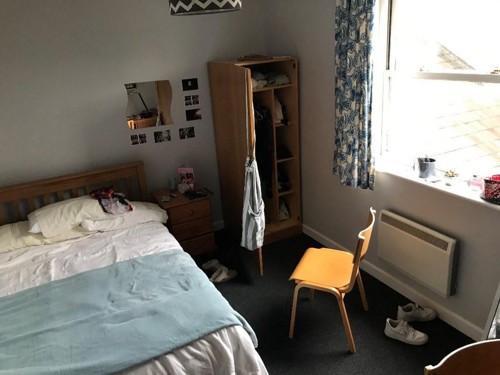 Cozy double bedroom featuring ample natural lig...