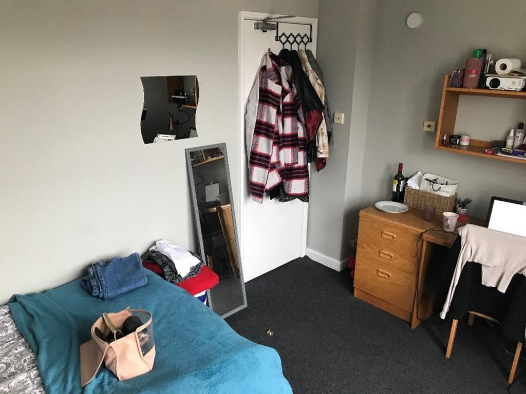 Cozy double bedroom featuring a comfortable bed...