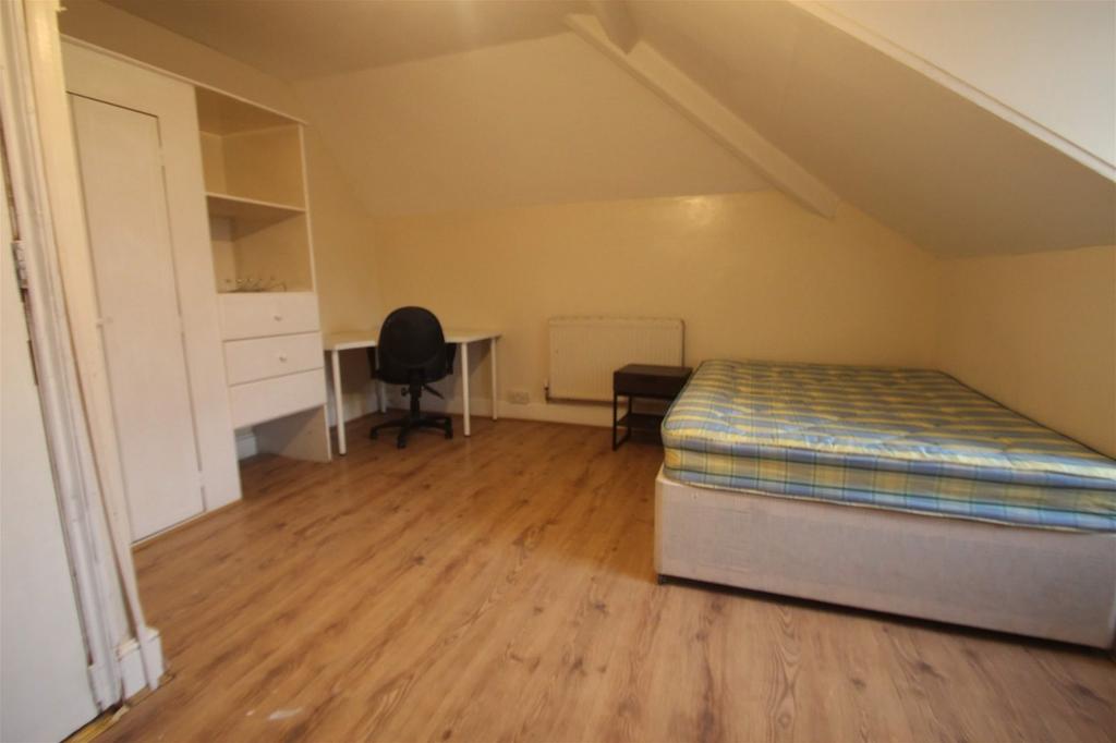 Spacious double bedroom featuring a comfortable...
