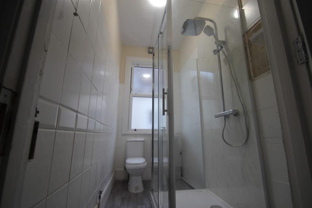 This modern bathroom features a stylish shower ...