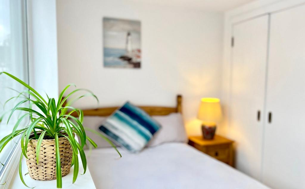 Bright and inviting double bedroom featuring a ...