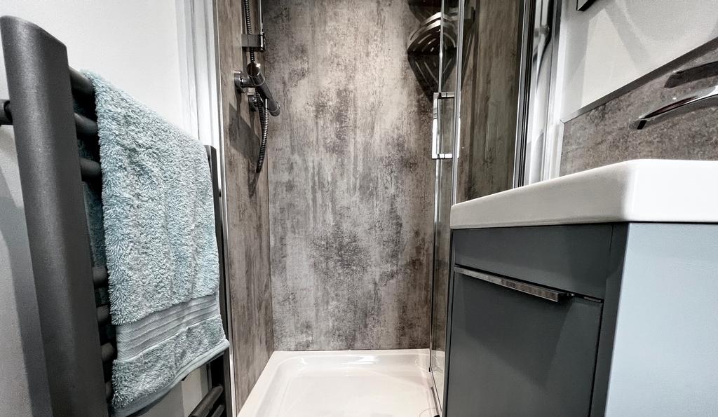 A modern and sleek bathroom featuring a stylish...