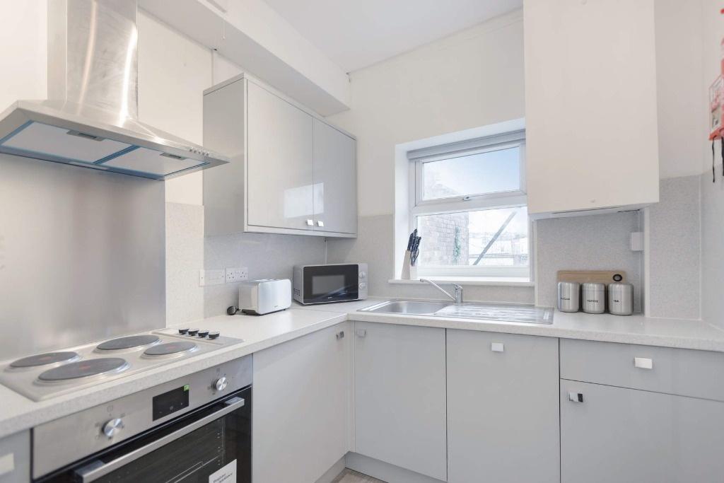 This modern kitchen features sleek cabinetry an...