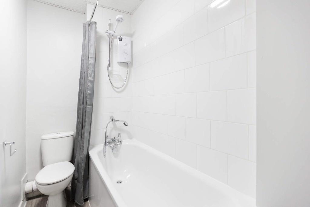 Bright and modern bathroom featuring a clean ba...