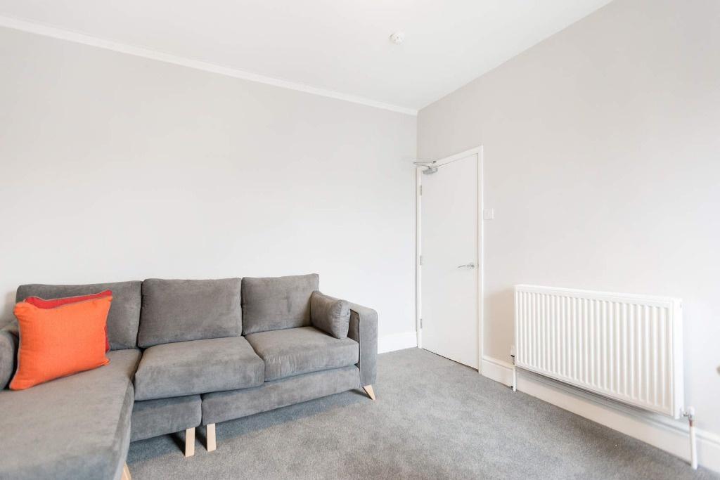 This inviting living room features a cozy secti...