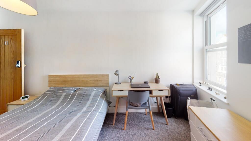 This spacious double bedroom features modern de...