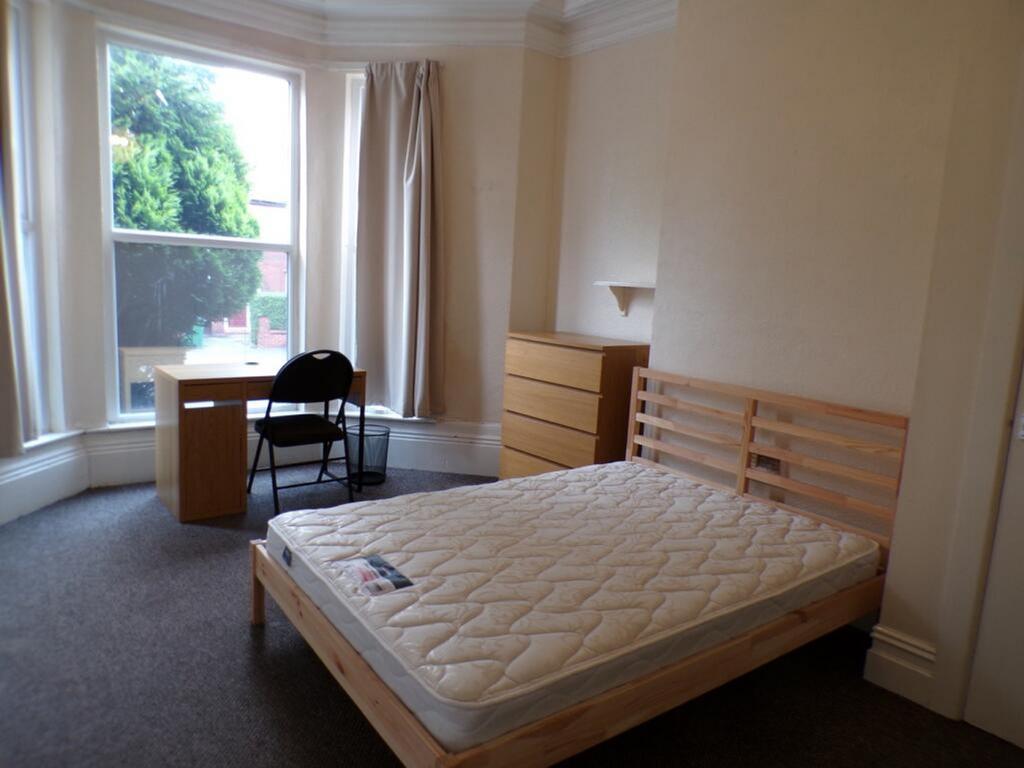 Spacious double bedroom featuring large windows...