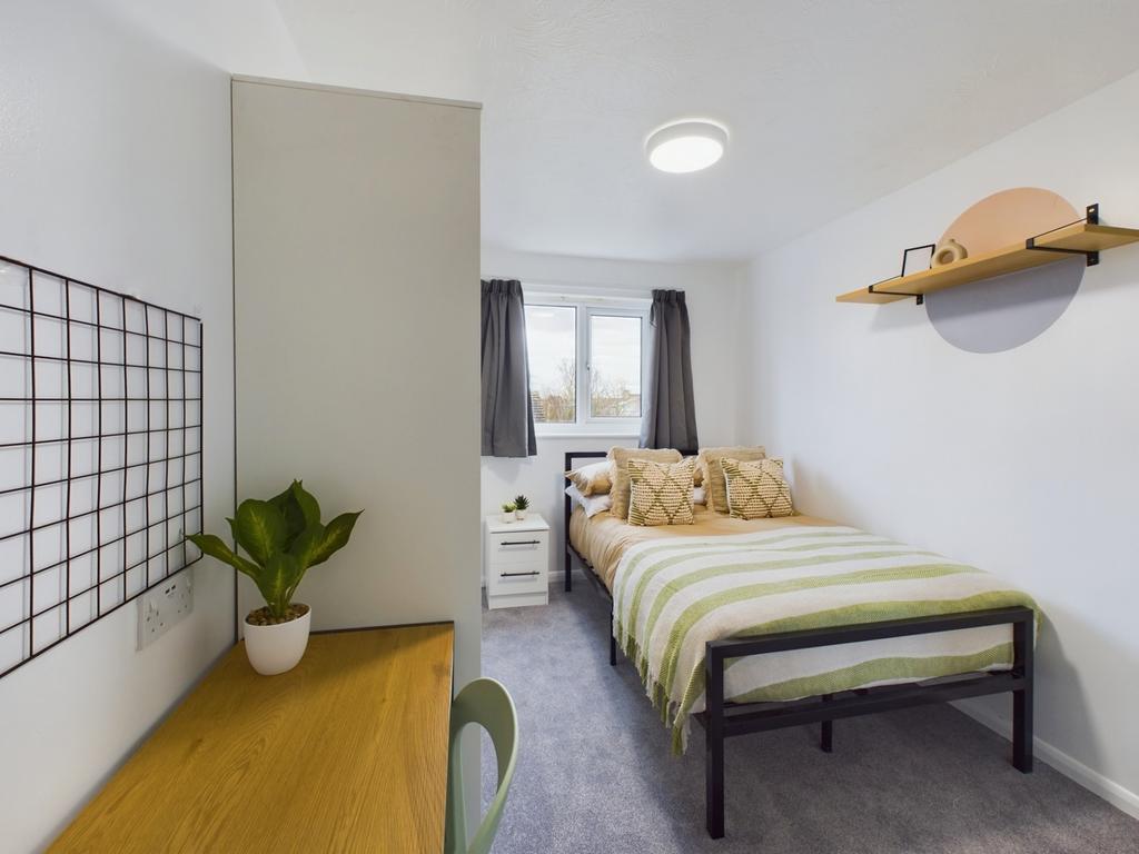 A bright and stylish double bedroom featuring m...
