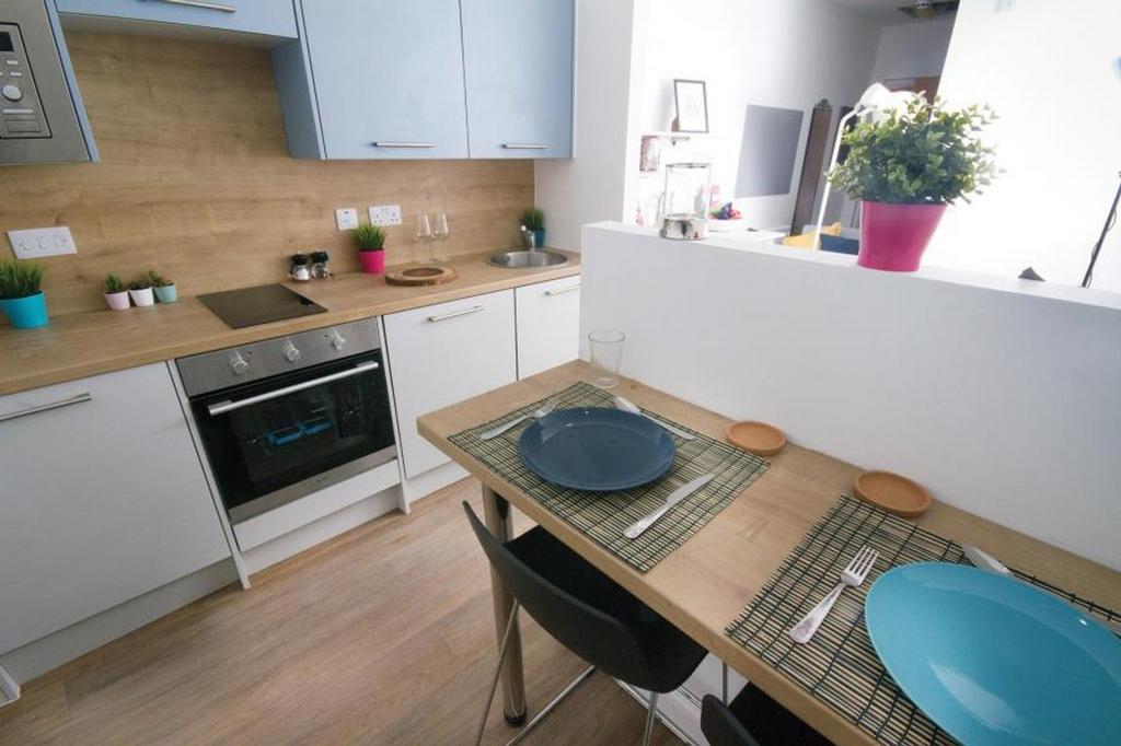 A modern kitchen featuring sleek cabinetry and ...