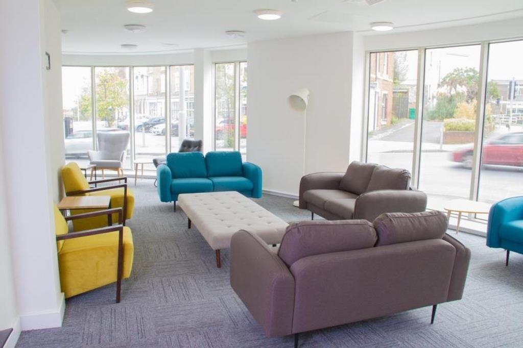 Spacious and well-lit communal lounge featuring...