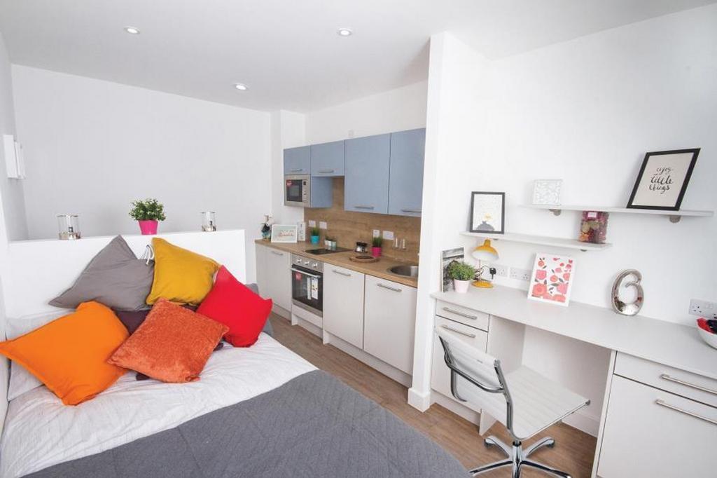 This inviting double bedroom features a cozy be...