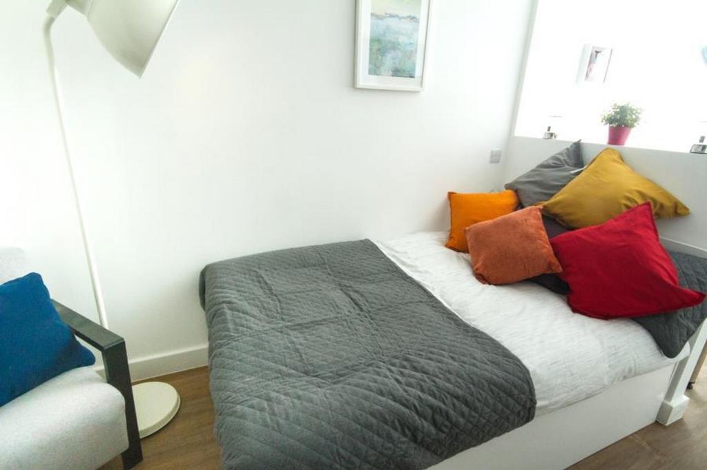 This cozy double bedroom features a comfortable...
