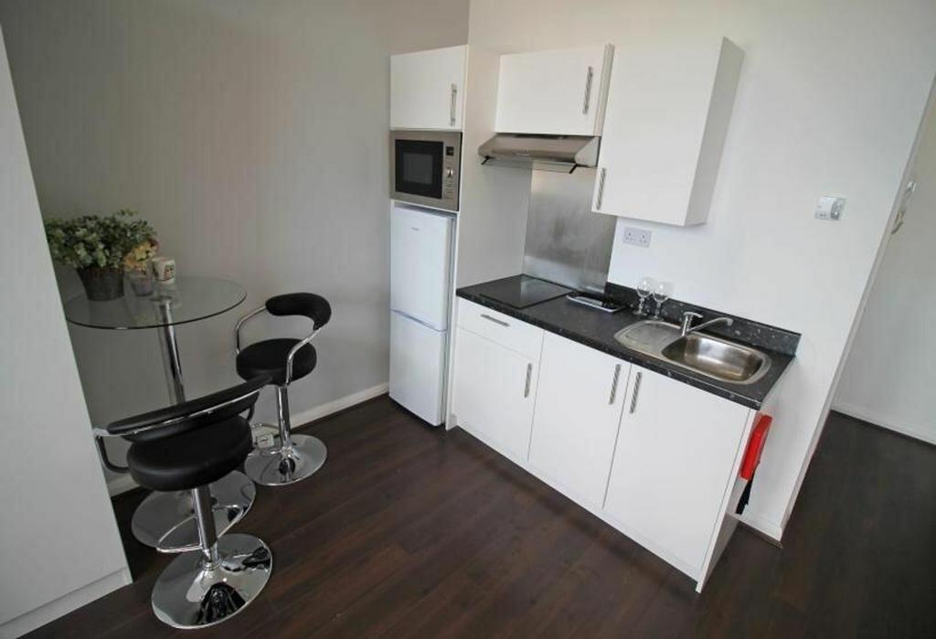 Modern kitchen featuring sleek cabinetry, a con...