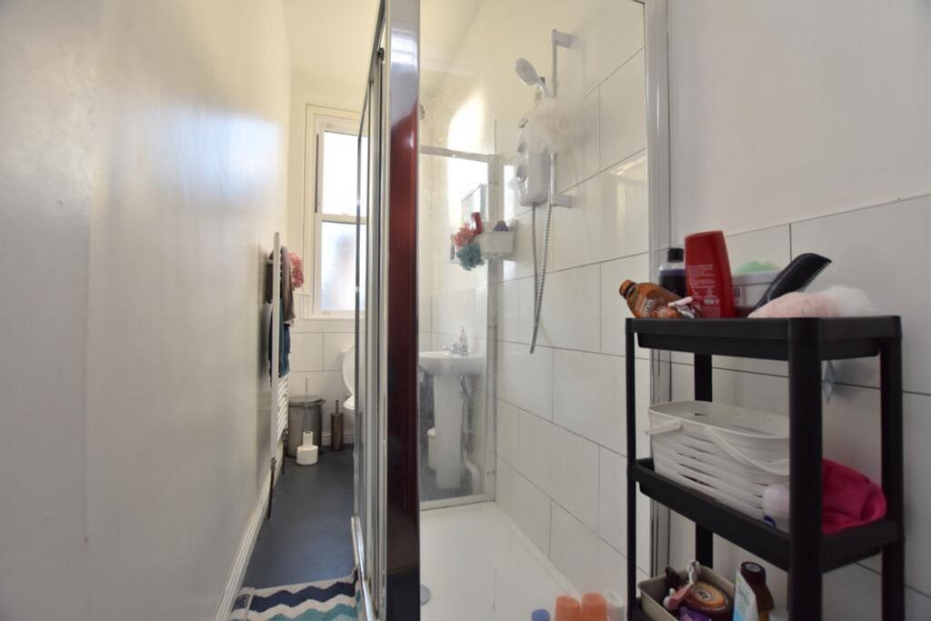 A modern bathroom featuring a spacious shower a...