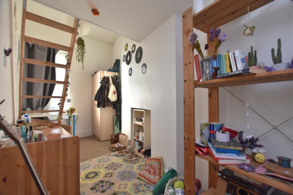 A charming hallway featuring a cozy staircase, ...
