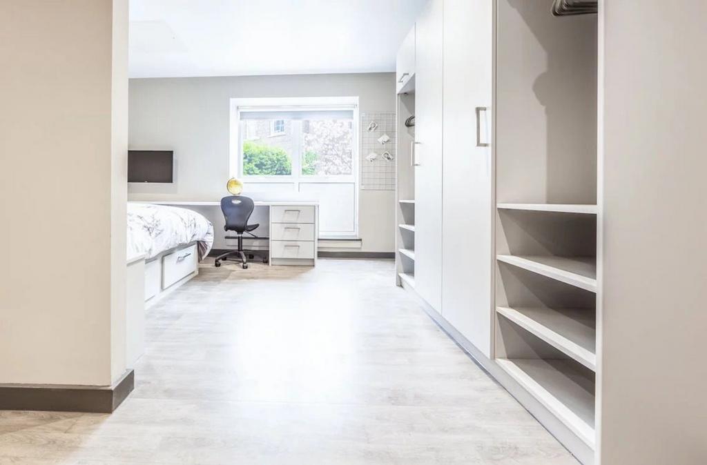 A spacious and bright double bedroom featuring ...