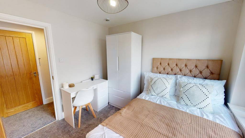 A bright and inviting double bedroom with moder...