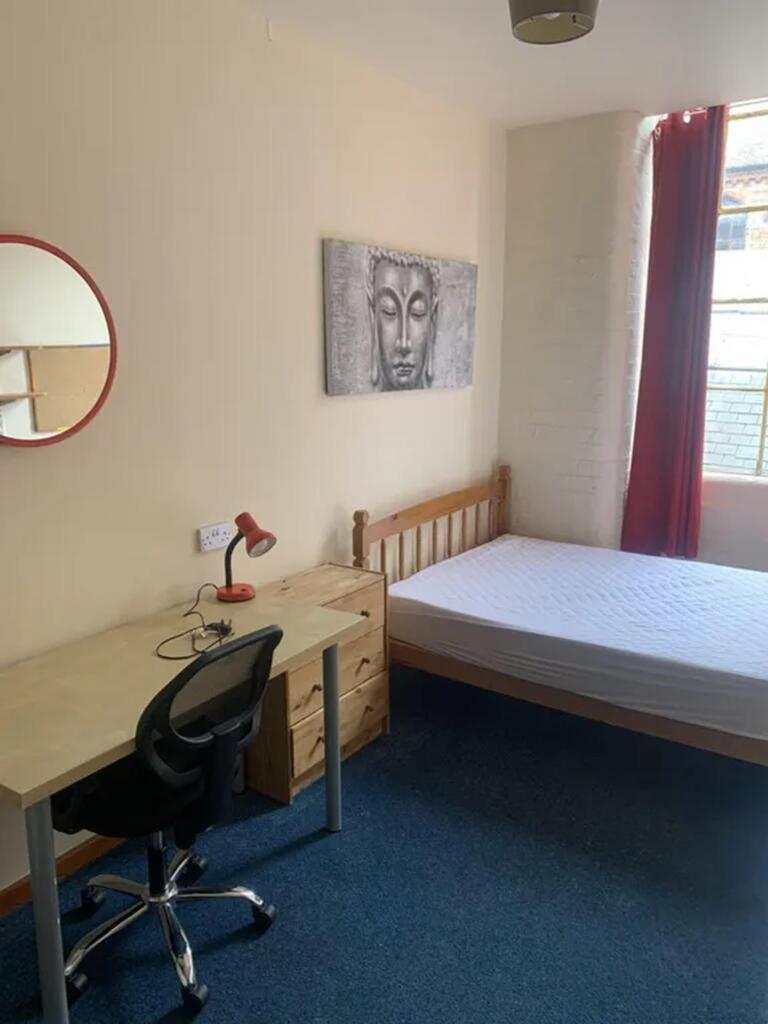 A cozy double bedroom featuring ample natural l...