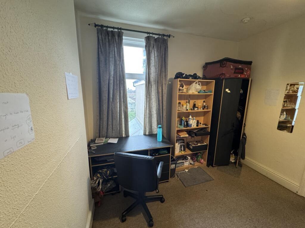 A cozy double bedroom featuring a dedicated stu...