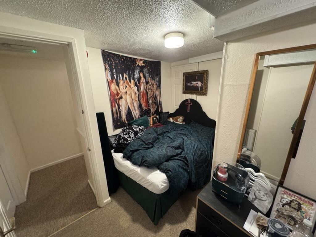 Cozy double bedroom featuring a comfortable bed...