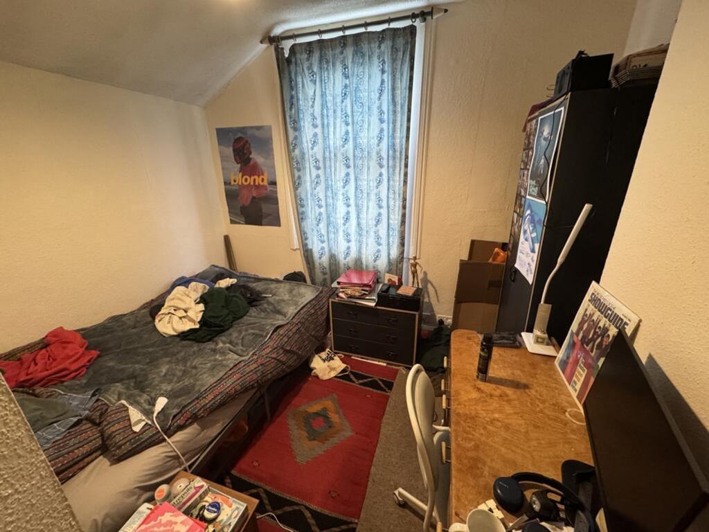 Cozy double bedroom featuring a comfortable bed...