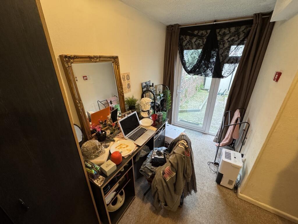 A cozy double bedroom featuring a stylish desk ...