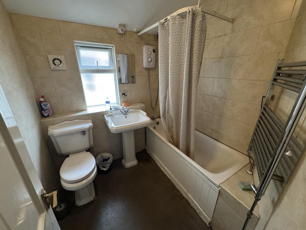 Bright and well-maintained bathroom featuring a...