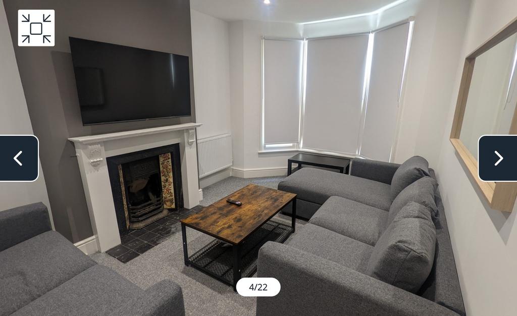 A spacious and inviting modern living room, per...