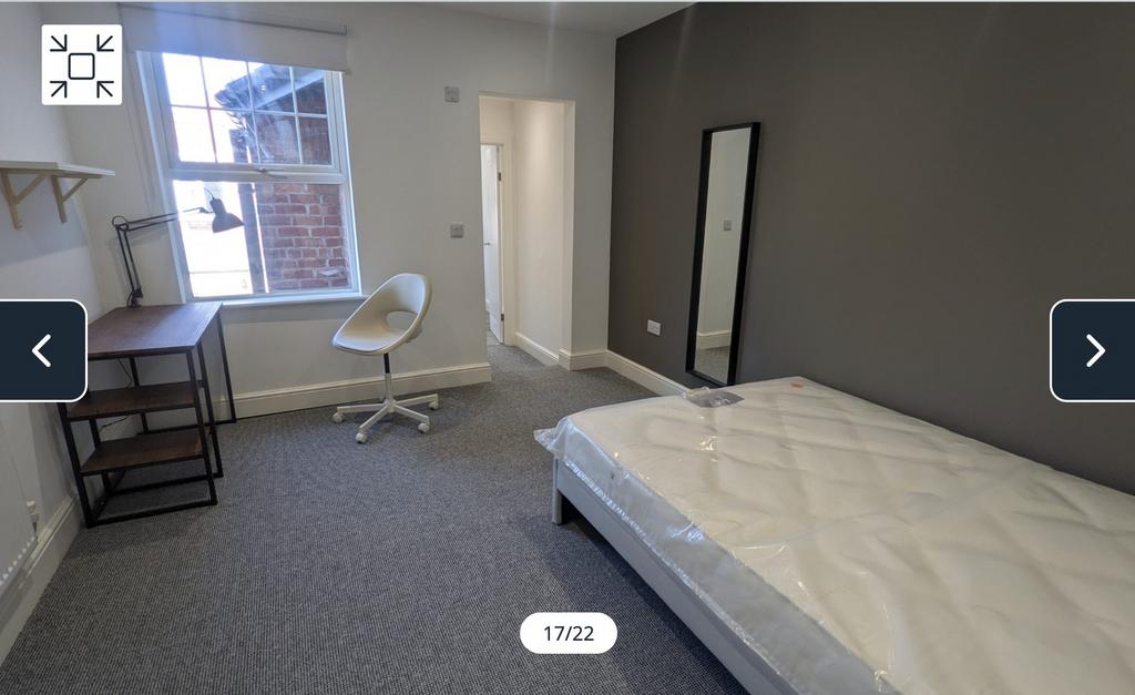 A bright and spacious double bedroom featuring ...